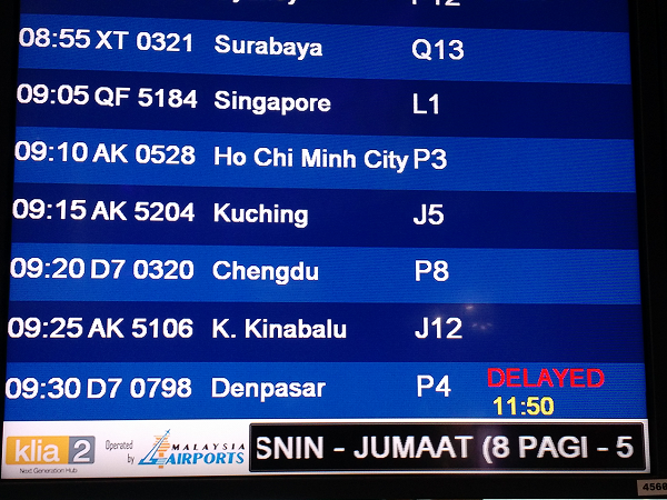 Flight information showing flight to Denpasar, Bali, is delayed by 2 hours 20 minutes