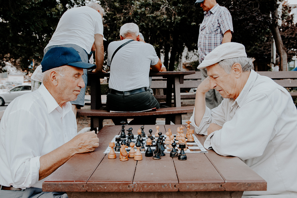 Old men playing chess in a park